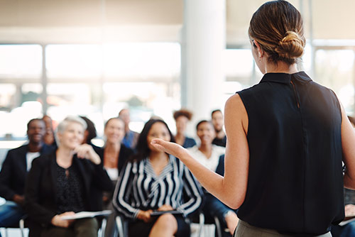A woman presenting at a conference