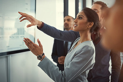 A woman presenting at a conference
